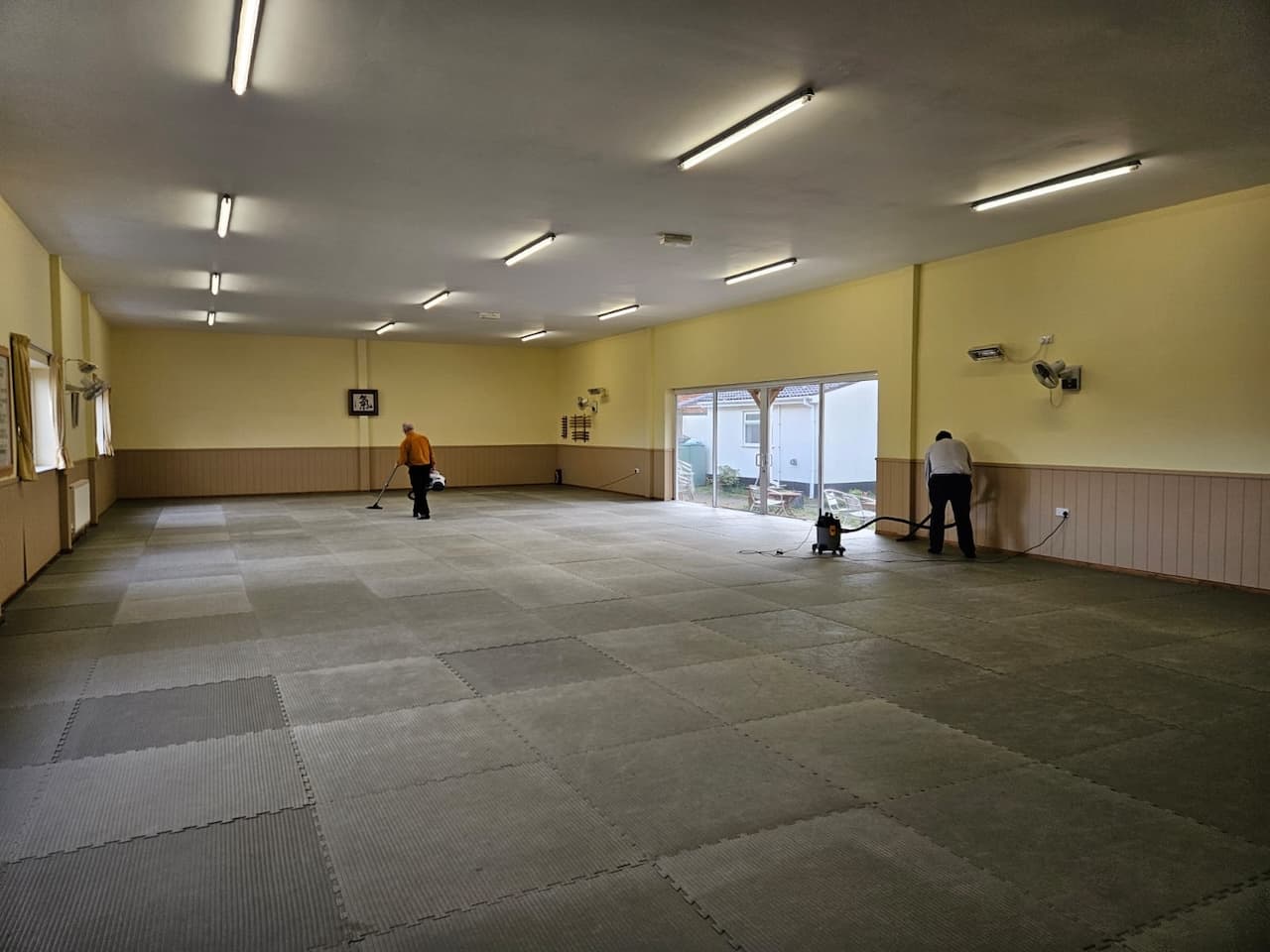 Before class, hoovering the mat