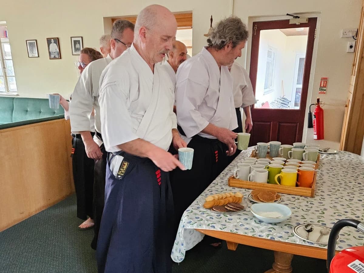 Attendees collecting their tea and biscuits
