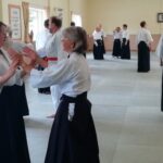 A daughter tests her mother's stability in the ikkyoundo exercise.