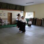 One student throws another in shihonage