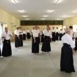 A wide view of the mat with pairs testing each other's unraise-ability.